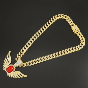 Golden Cuban link chain with a red ruby angel wing pendant and crystal rhinestones