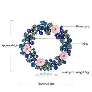 Spilla ghirlanda floreale con strass blu e fiori rosa in finitura oro antico