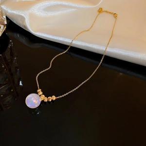 Detailed view of titanium steel necklace with fishtail pearl pendant on white silk