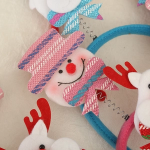 Detailed view of Santa Christmas headbands with snowman and reindeer ornaments in festive colors