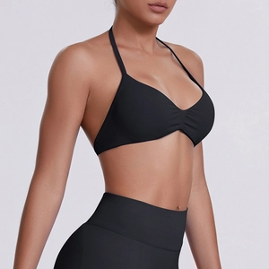 Detailed view of the halter neck sports bra in seamless black high-stretch fabric