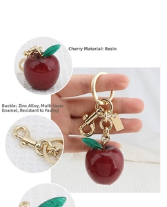 Detail of red resin cherry keychain with glitter leaf and anti-fade zinc alloy clasp