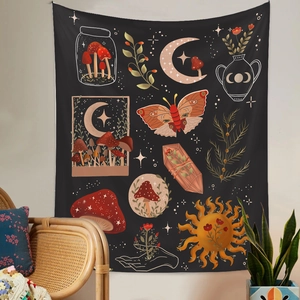 Detail of bohemian black tapestry with celestial moon and mushroom patterns for wall decor