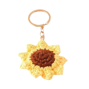 Handmade crochet sunflower keychain with bright yellow petals and gold ring on white background