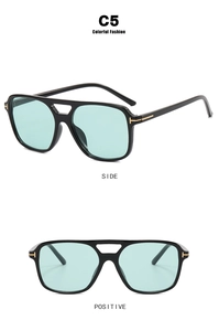Detail of square pilot sunglasses with green lenses and gold T-shaped temple accents