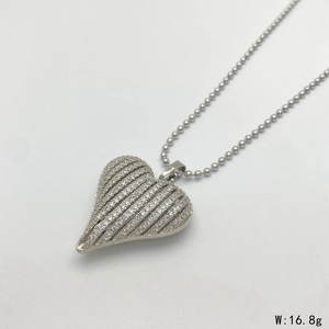 Detailed view of silver striped heart pendant with micro-inlaid zircon and ball chain