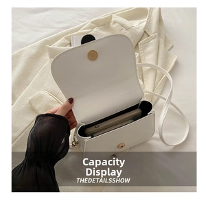 Internal view of the white square crossbody bag showing capacity for a smartphone