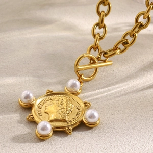 Detail of 18K gold plated coin pendant with white pearls on a chunky OT buckle chain