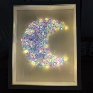 DIY moon crystal night light with warm LED lights in a minimalist white frame