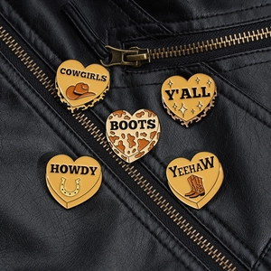 Detail of 5-piece Western cowboy heart enamel pins pinned on a black leather jacket