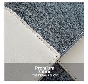Close-up of contrast color patchwork showing grey-blue linen fabric and off-white leather