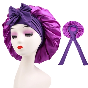 Close-up of purple satin sleep bonnet with long stretch ties for hair protection