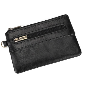 Detail view of black vintage leather coin purse featuring dual zippers and bronze D-ring