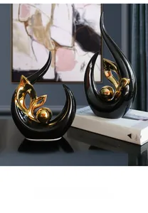 Detail of modern ceramic abstract art sculptures in black and gold on a stylish display