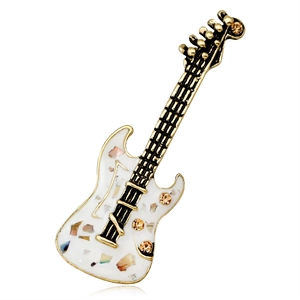 Vintage guitar brooch with colorful stones and amber rhinestones on a white background