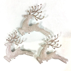 Three silver metal reindeer Christmas ornaments with textured surface and large antlers