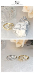 Detailed view of gold and silver open rings with sparkling star and rectangle zircon settings