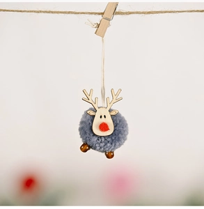 Macro shot of grey felt reindeer ornament with wooden antlers hanging on a twine rope