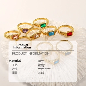 Detail of vintage 18k gold plated titanium steel rings with colored rectangular crystals