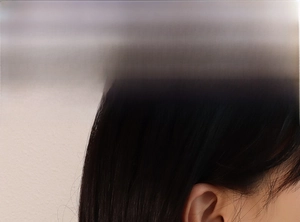 Close-up model shot showing minimalist titanium steel bead earrings for women