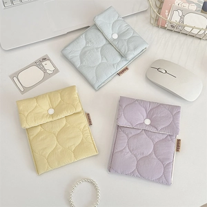 Detailed view of colorful quilted storage pouches for sanitary pads or lipstick