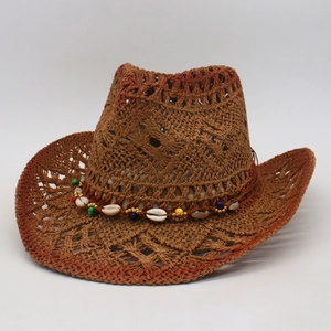 Detail of western straw sun hat featuring woven patterns and ethnic beads decorative band
