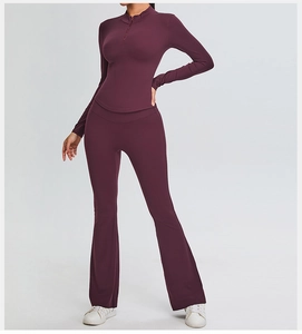 Detail view of burgundy slim-fit yoga set with half-zip top and flared trousers