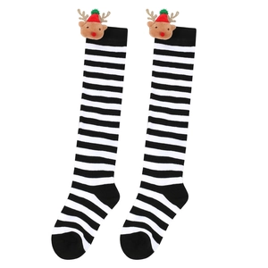 Detailed view of striped Christmas knee high socks featuring cute plush reindeer doll accessories