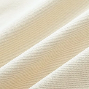 Macro shot of cream-colored twill fabric texture on a vintage French work jacket