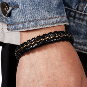 Men's retro multi-layer woven black leather and gold steel wire bracelet on wrist