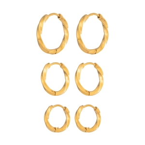 Three pairs of twisted gold hoop earrings in graduated sizes with a polished finish