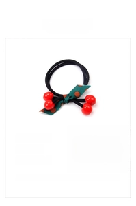 Detail of cherry streamer hair ring with red resin beads and polka dot bow ribbon