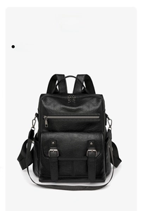 Front detail of black leather backpack featuring metal buckles and zipper pockets