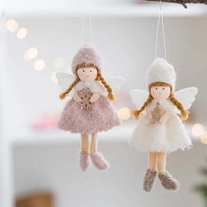 Detail of plush Christmas angel ornaments in pink and beige with knitted textures