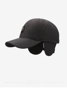 Detail of dark grey winter baseball cap featuring folding ear flaps and wool texture