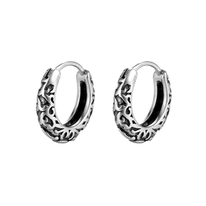 Detailed view of vintage titanium steel hoop earrings with intricate carved hollow patterns