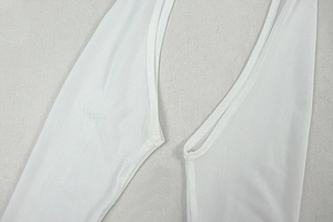 Detailed close-up of white breathable mesh fabric stitching on a slim-fit dress
