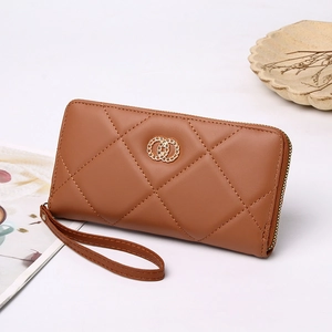 Brown quilted leather long wallet with golden ring buckle and wristlet on white background