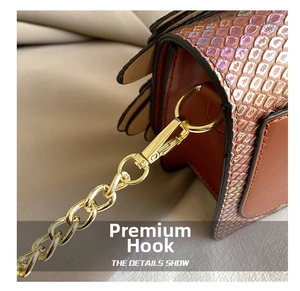 Detail of the high-quality metal hook and gold chain on the snakeskin crossbody bag
