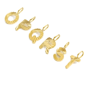 Detailed view of golden letters O to T with textured finish and top jump rings