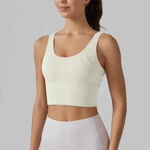 Close-up of cream yellow V-neck sports bra with wide shoulder straps for yoga and fitness