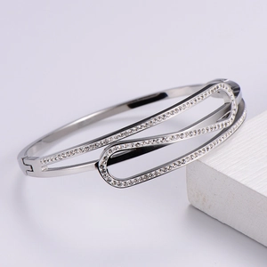 Macro shot of a silver bracelet featuring geometric hollow design and paved white zircons