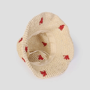 Detail view of beige crochet straw hat with breathable hollow pattern and inner sweatband