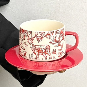 Ceramic coffee cup and saucer set featuring red elk and floral patterns for couples