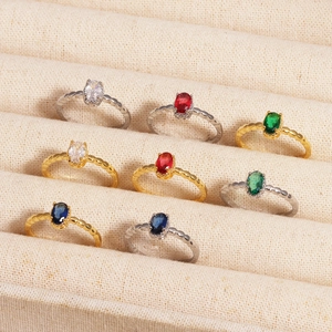 Variety of minimalist open rings with colorful oval stones in gold and silver settings