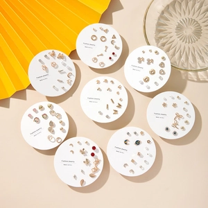 Detailed view of fashion earring sets with pearls and crystals on display cards