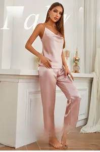 Pink silk satin two-piece pajama set with spaghetti strap top and wide-leg trousers