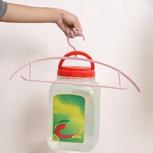 Pink semi-circle plastic clothes hanger demonstrating high weight-bearing capacity