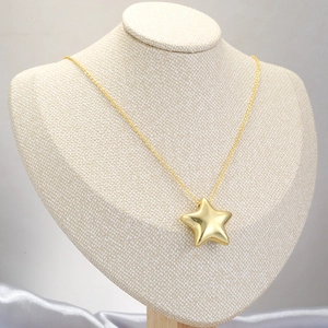 French vintage style gold star pendant necklace with delicate chain on model