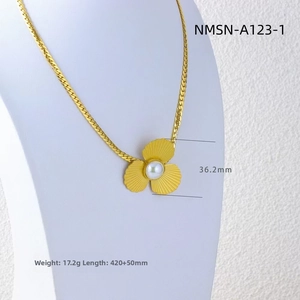 Detail of flower pendant necklace with brushed gold petals and a central pearl accent
